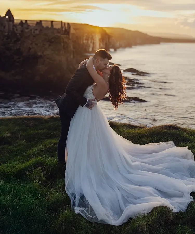 Elopement Couple overlooking Dunluce Castle at Sunset in Ireland